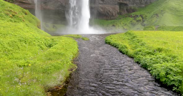 Seljalandsfoss waterfalls in Iceland with video tilting up in slow motion.