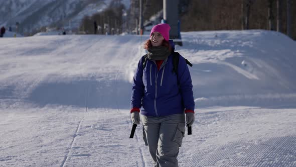 Sporty Traveller Woman is Walking in Ski Resort at Sunny Winter Day Happy Skier or Snowboarder