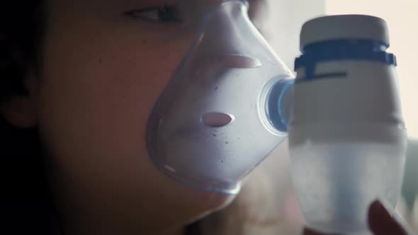 Close Up Footage of Childhood Asthma Inhaling Mask Illnesses Little Girl Doing Aerosol Independently