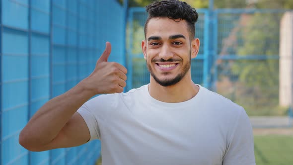 Cheerful Contented Middle Eastern Arabic Student Showing Thumbs Up Symbol Approval Support