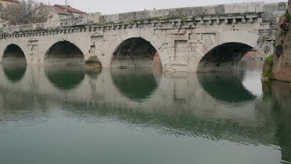 Bridge of Tiberius Arches Reflected in Calm River