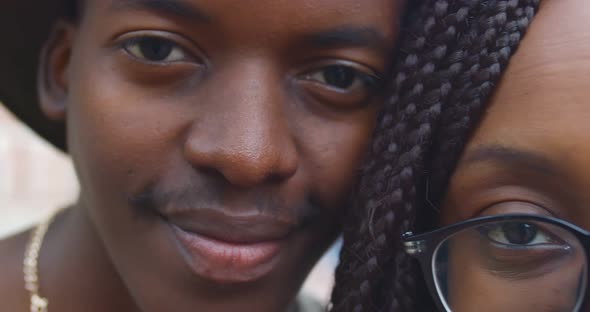 Macro Shot of Positive African Couple Smiling at Camera