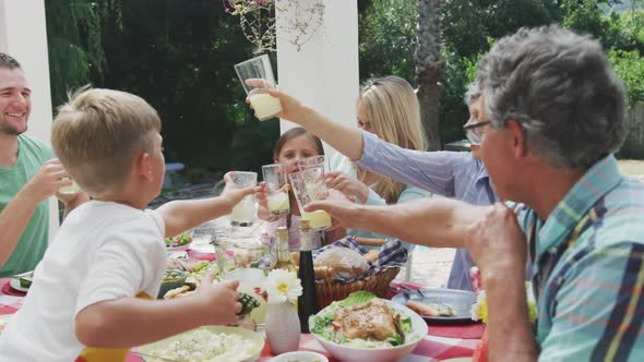 Happy family eating together at table