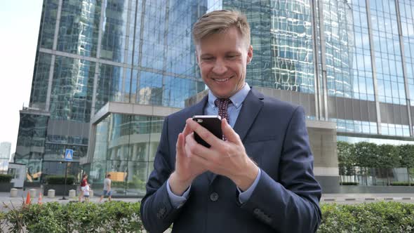 Businessman Using Smartphone Text Messaging