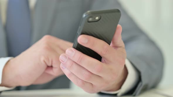 Close Up of Businessman Typing on Smartphone Mobile