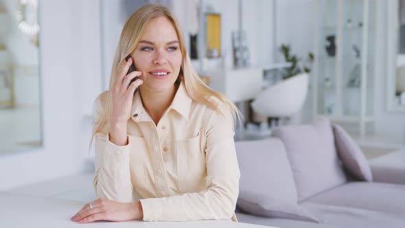 Attractive woman talking on smartphone indoors