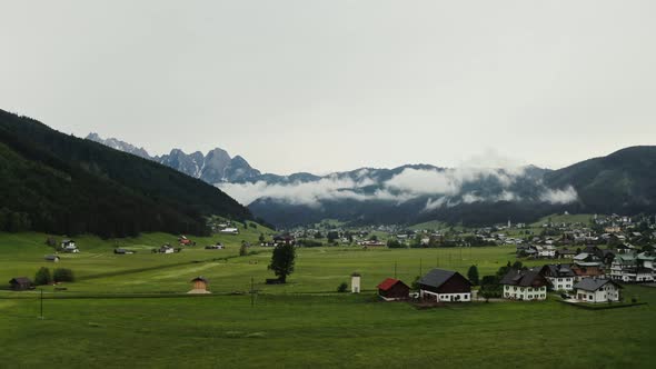 Panoramic View of a Picturesque Mountain Valley with a Village in a Lowland