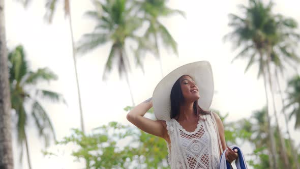 Woman In Sun Hat Walking Along On Nacpan Beach