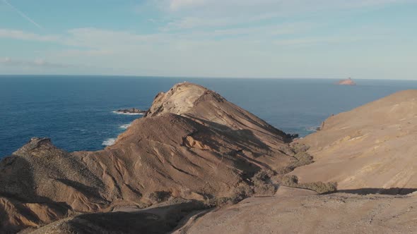 Drone pov flying over rocky promontory of Porto Santo island. Portugal