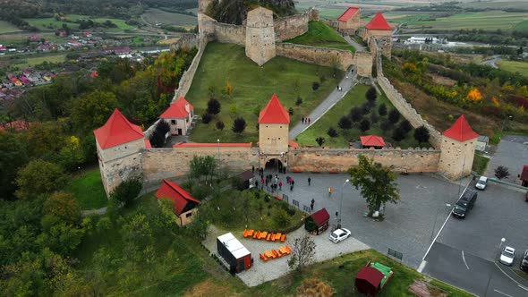 Aerial drone view of Rupea Fortress, Romania. Citadel located on a cliff, tourists