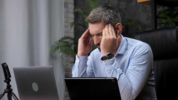 Man Trader Broker Works for Laptop Looks at Chart on Stock Exchange in Office