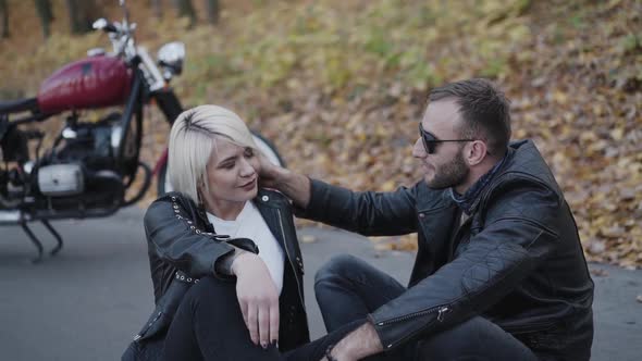 Lovely Couple Sitting on Road Man Caresses His Smiling Girl