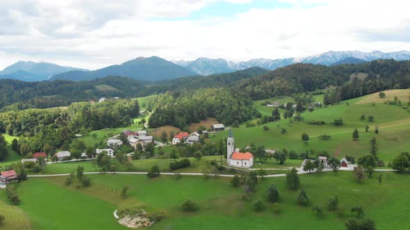 Aerial footage of remote mountain village. Rural landscape from air. Slovenian countryside in summer