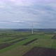 Aerial Shot of a Single Wind Turbine on Rural Agricultural Fields - VideoHive Item for Sale