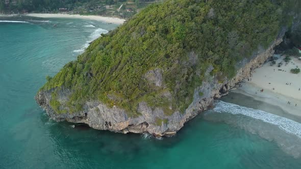 Aerial Top View of Sandy Beach with Mountain and Clear Water