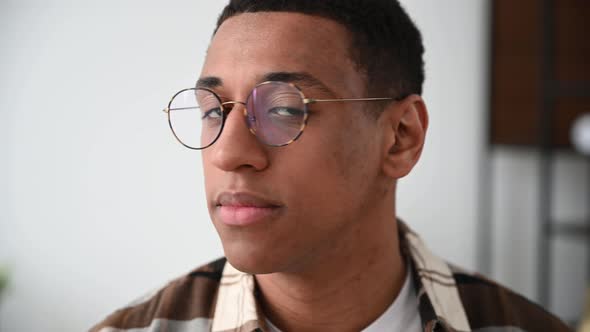 Closeup Video Portrait of a Handsome Positive Millennial Hispanic Guy with Glasses Freelancer or