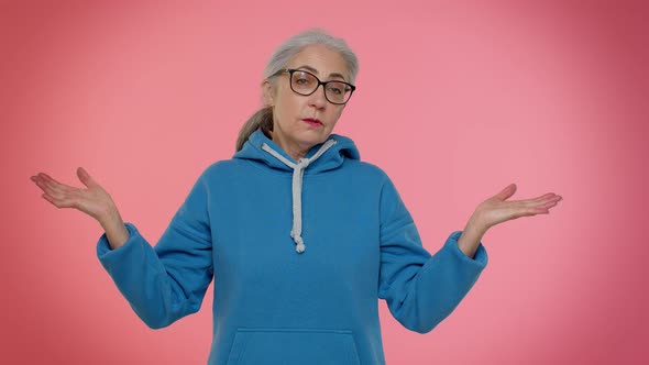 Puzzled Uncertain Senior Old Granny Woman Raising Hands in Helpless Gesture Difficult Question