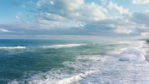 The Stormy Waves of the Ocean in the Evening with Cloudy Day