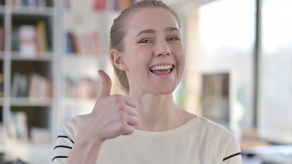 Portrait of Thumbs Up By Approving Young Woman 