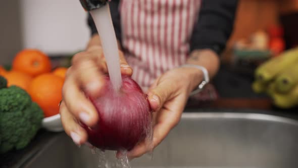 Female Hands Washing Apple Under Water in Sink