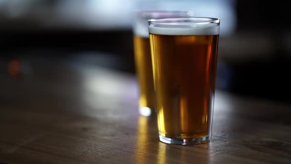 close up shot of two pints of beer with rising bubbles