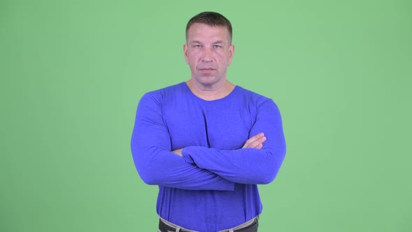 Macho Mature Man with Arms Crossed