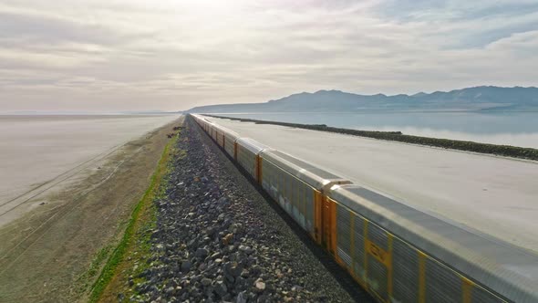 AERIAL - Train on railway, Great Salt Lake, Utah, forward shot truck right