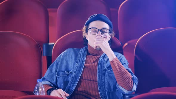 A Man is Getting Tense While Watching a Film at the Cinema