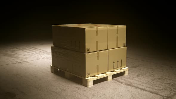 A stack of cardboard boxes on a pallet in the warehouse waiting for a forklift.