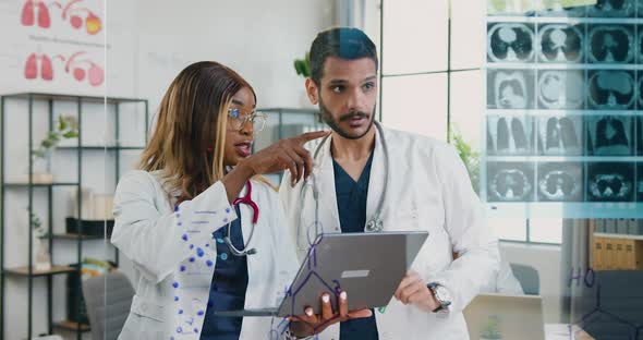 Doctors Working with Results of X-ray Scan and Information About Patient's Diagnosis