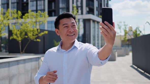 Asian Business Man Having Online Video Call Smiling Using Mobile Phone Outdoor