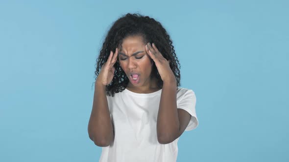 African Girl with Headache Isolated on Blue Background