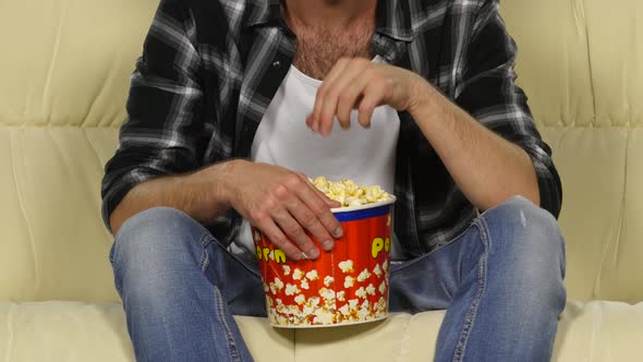 Male Hands Holding a Bucket of Popcorn