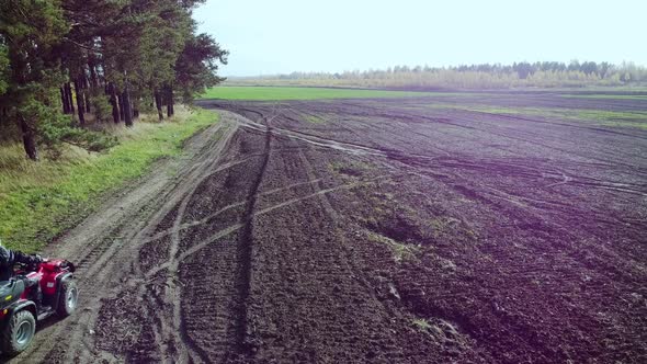 Offroad Quad Biking Along the Forest and Field Shooting with a Drone