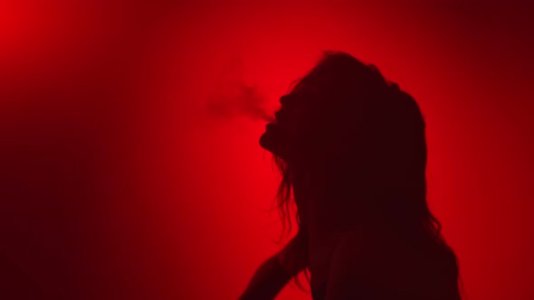 Sensual Passion Woman Smoking Blowing Smoke at Night Party Red Studio