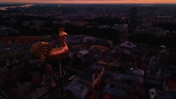 Riga's Golden Weather Cock or Rooster in Beautiful Old Town During Amazing Scenic Sunrise Aerial