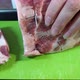 A woman cuts a large piece of pork meat with a knife. Meat with fat layers, pork neck. 4k - VideoHive Item for Sale