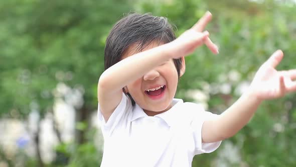 Close Up Of Happy Asian Child Dancing Outdoor Slow Motion