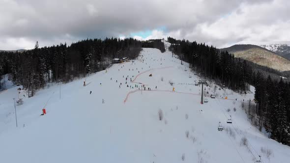 Aerial View on Ski Slopes with Skiers and Ski Lifts on Ski Resort in Winter