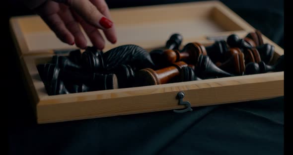 Close Up of Chess Pieces in Chessboard on Black Background