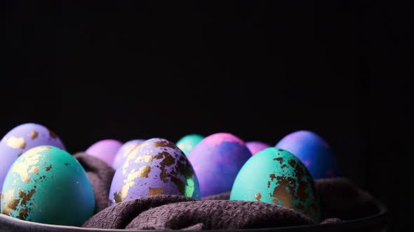 Easter eggs rotating on black background.