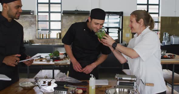 Caucasian female chef teaching diverse group