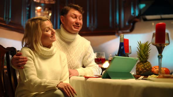 Positive Couple Celebrating Anniversary Talking Online Using Video Chat on Tablet