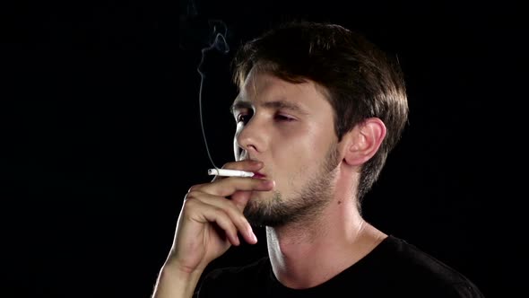 Bad Habits. Man in Depression with Cigarette. Black. Close Up. Slow Motion