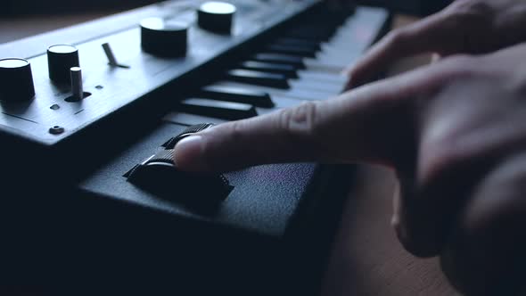 Musician playing on musical keyboard.