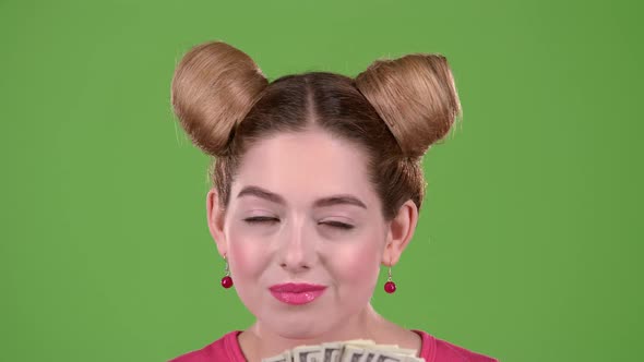 Girl Sniffs Paper Bills and She Is Delighted. Green Screen. Close Up. Slow Motion