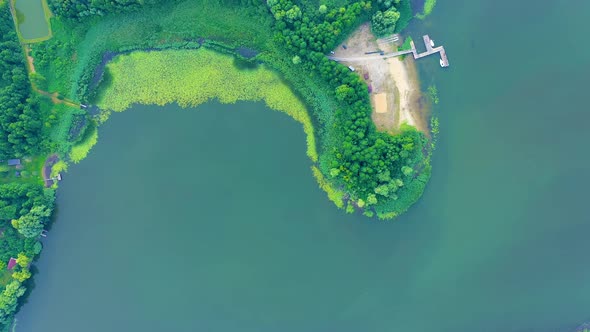 Epic Top Down Aerial View of Big Lake With Clear Blue Water. Reflection of Sky in Clear Lake in Even