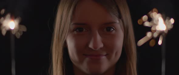 Close up Of a Woman Smiling to The Camera with Two Sparkles in The Background 