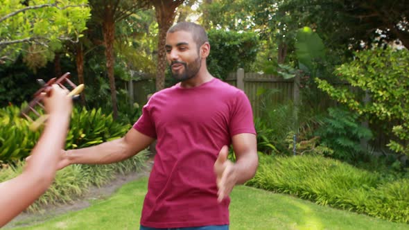 Father and son playing in garden 4k