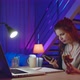 Beautiful Girl Student Makes Sketches In A Sketchbook Using Laptop At Home Office In The Evening. - VideoHive Item for Sale